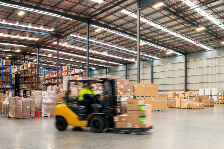 Forklift working at logistics warehouse
